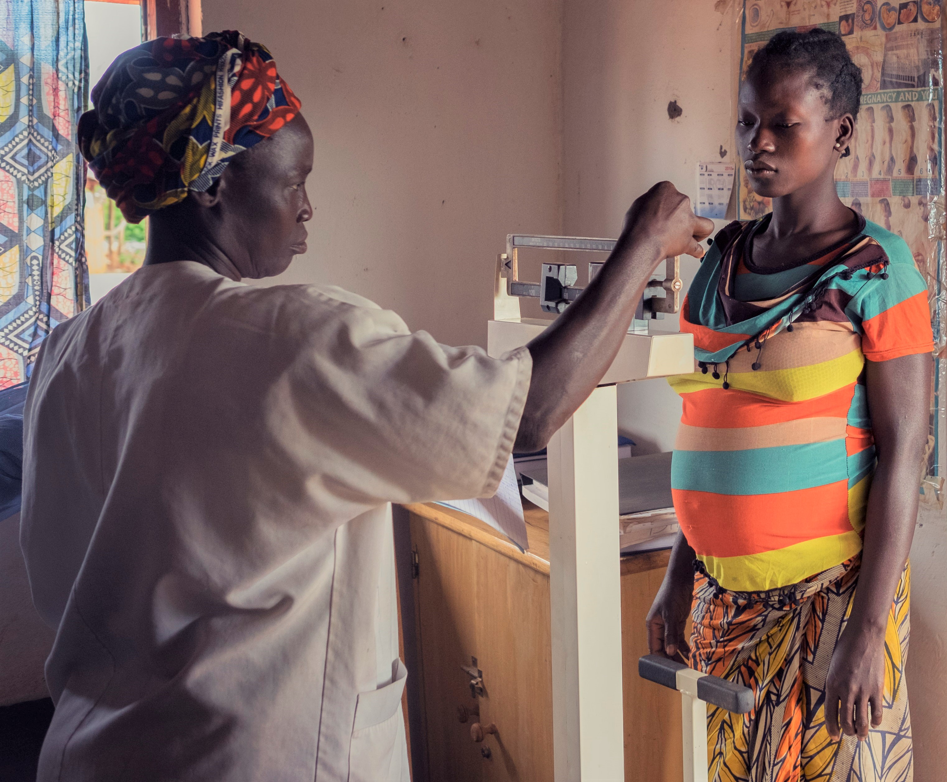 A provider weighs a pregnant woman in the Central African Republic. 